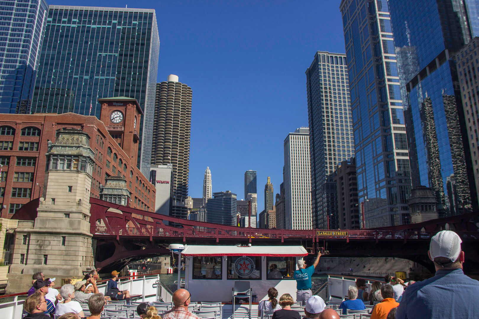 Wendella architecture tour boat cruising down the Chicago River surrounded by historic skyscrapers